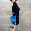Watercolor of a boy at the beach in San Diego holding a bucket and shovel.